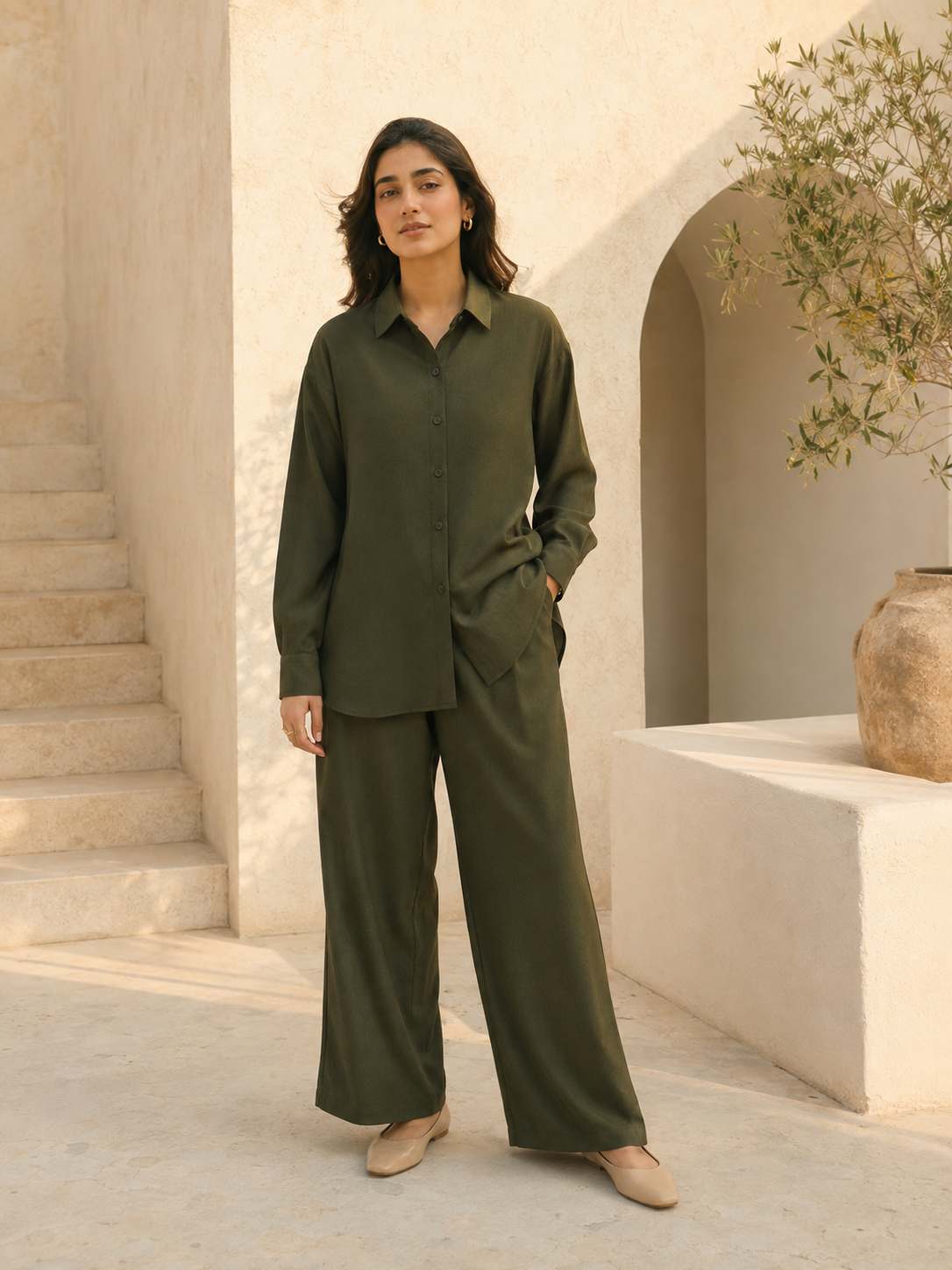 A woman wearing a solid olive shirt and wide-leg co-ord set.